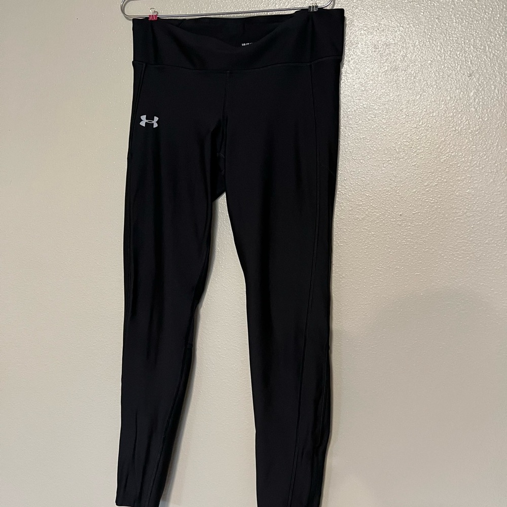 Size large underarmour leggings with mesh and zipper detail, great for running